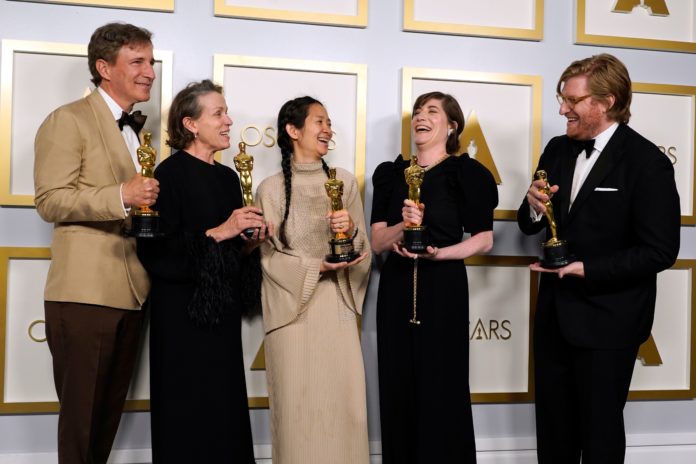 Producers Peter Spears (from left), Frances McDormand, Chloe Zhao, Mollye Asher and Dan Janvey, winners of the award for best picture for 