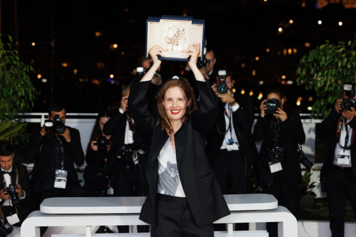 Justine Triet poses with The Palme D'Or Award for 